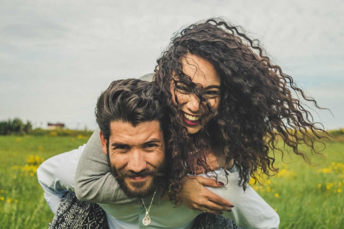 Unsplash: Man and woman couple smiling for the camera by Chermiti Mohamed