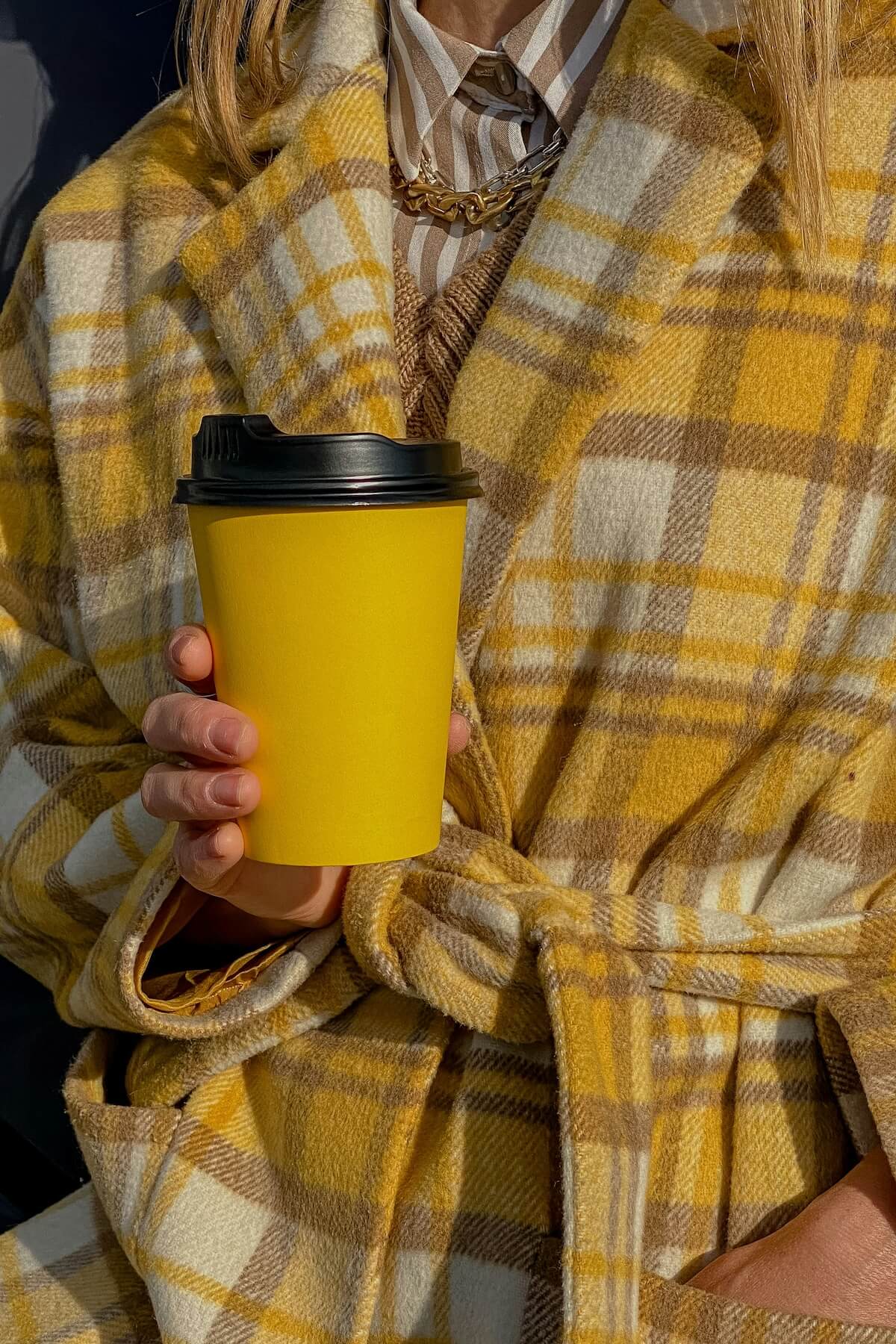 Unsplash: Woman in yellow plaid with coffee cup by Valeriia Svitlini