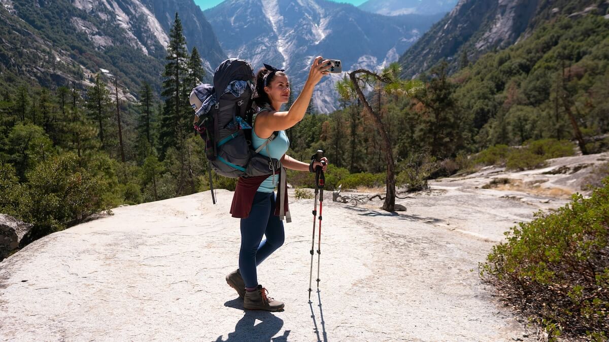 Unsplash: Woman taking hiking photo by Joshua Gresham