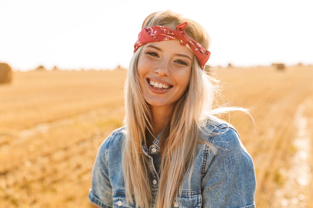 Shutterstock: Smiling young blonde girl in headband at the wheat field
