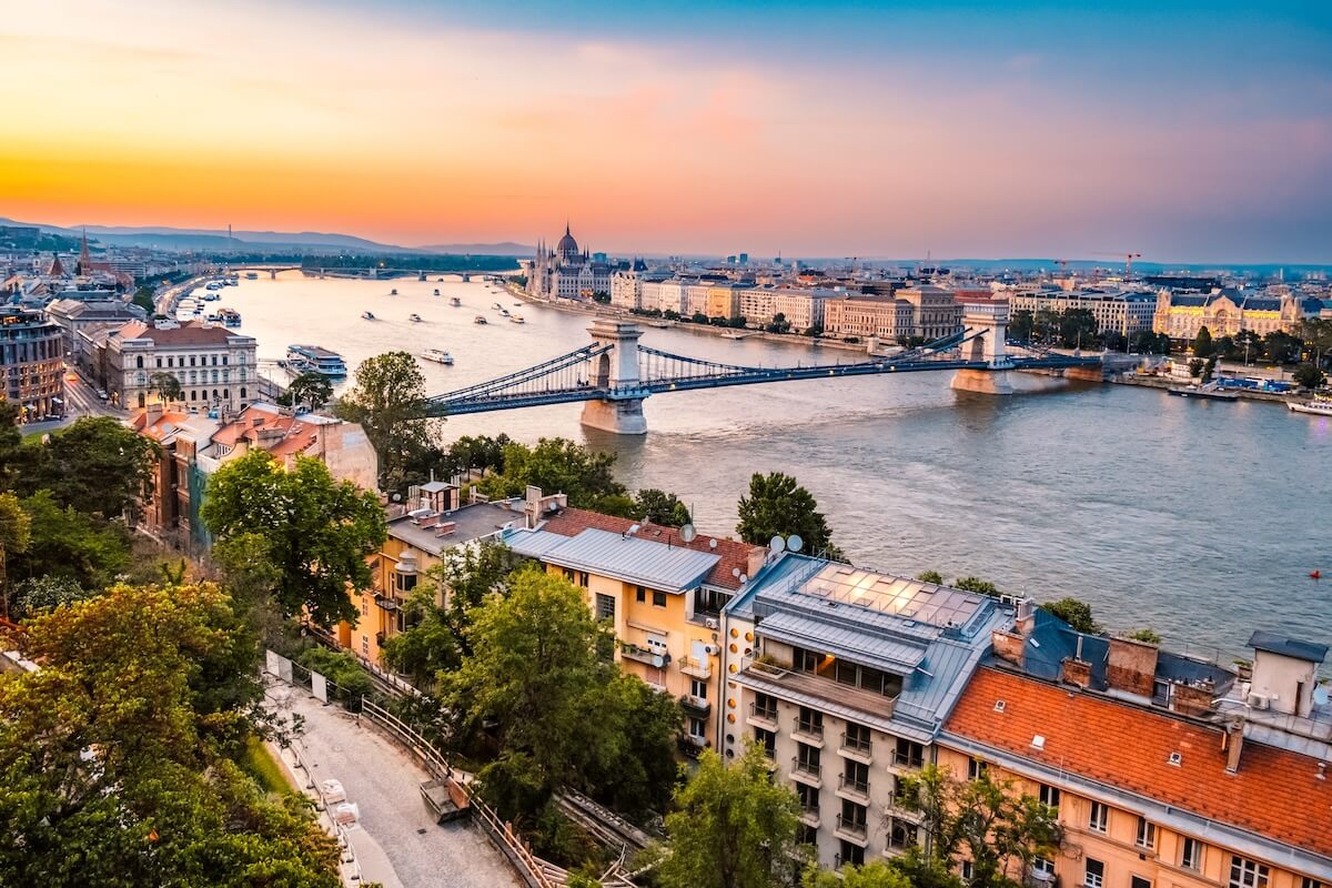 Shutterstock: Parliament building in Budapest with fantastic perfect sky and reflection in water. calm Danube river. Night view on Parliament building over delta of Danube river.