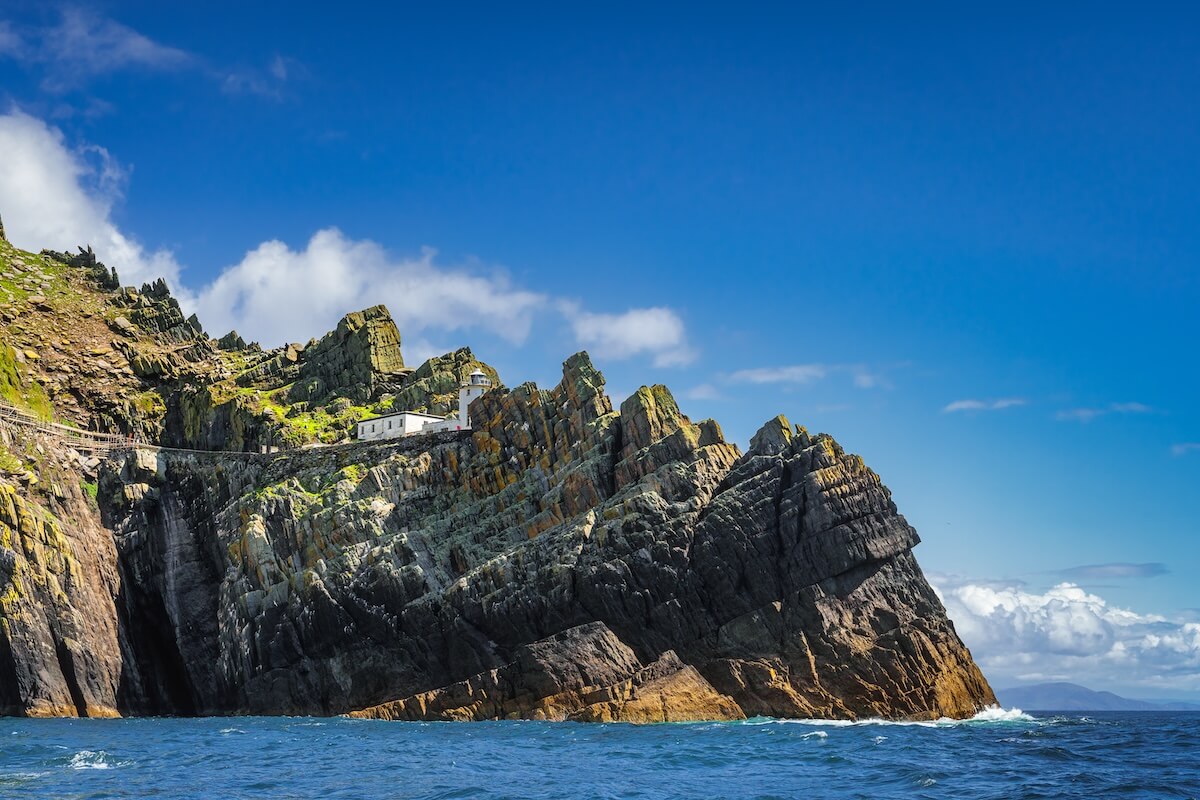 Shutterstock: Skellig Lighthouse located on the edge of the cliff on Skellig Michael island where Star Wars were filmed, UNESCO World Heritage Ring of Kerry Ireland