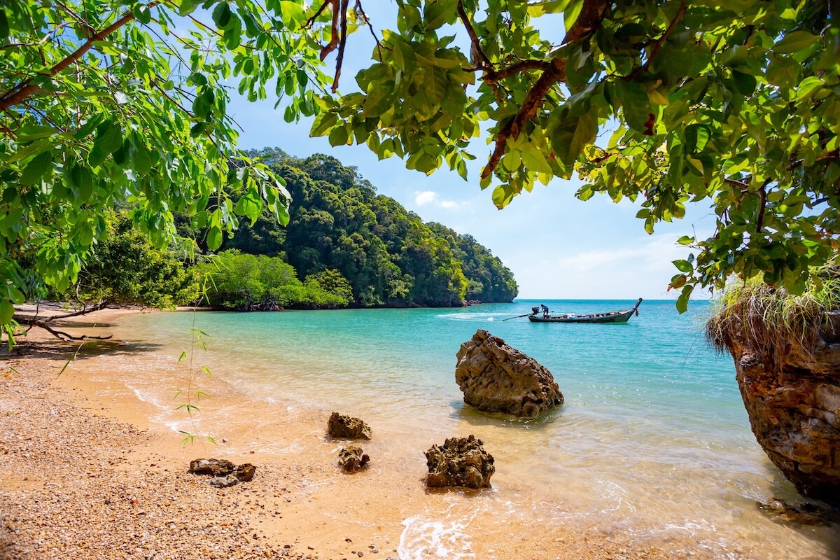 Shutterstock: Railay, Krabi, Thailand. Beach and long tail boats.