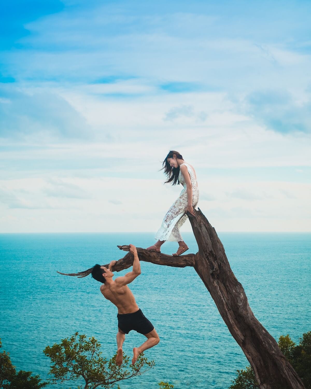 Unsplash Man and Woman at beach hanging on tree Tiraya Adam