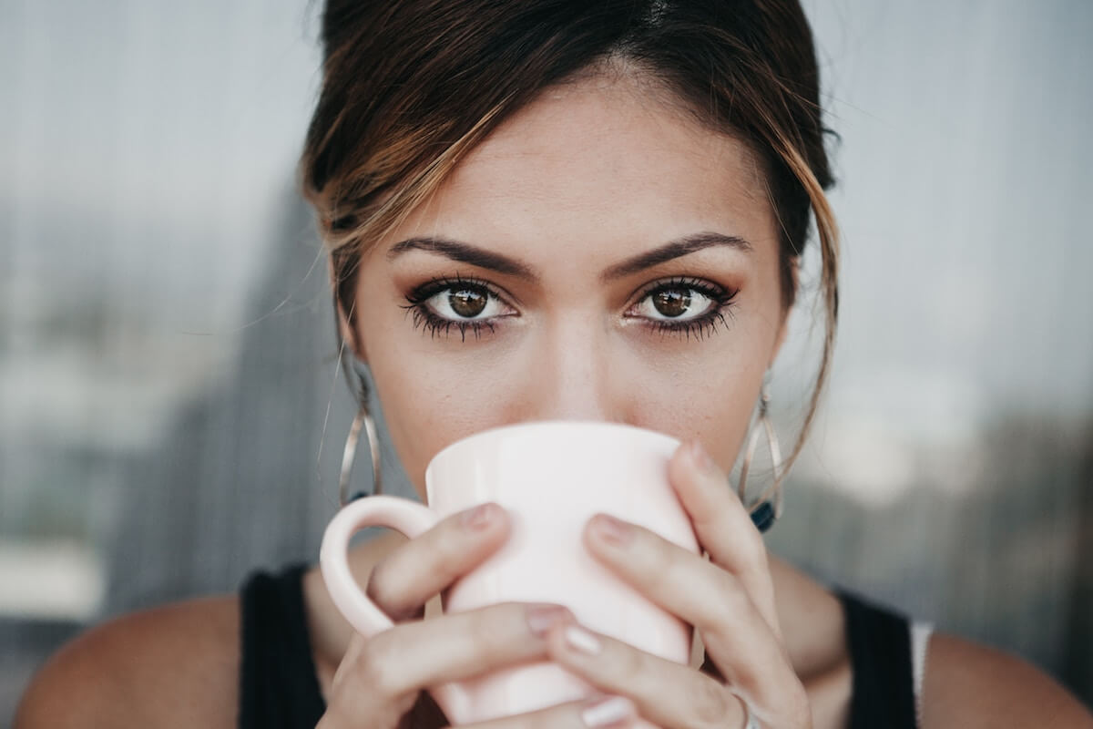 Unsplash Woman starring intensely drinking from cup Candice Picard