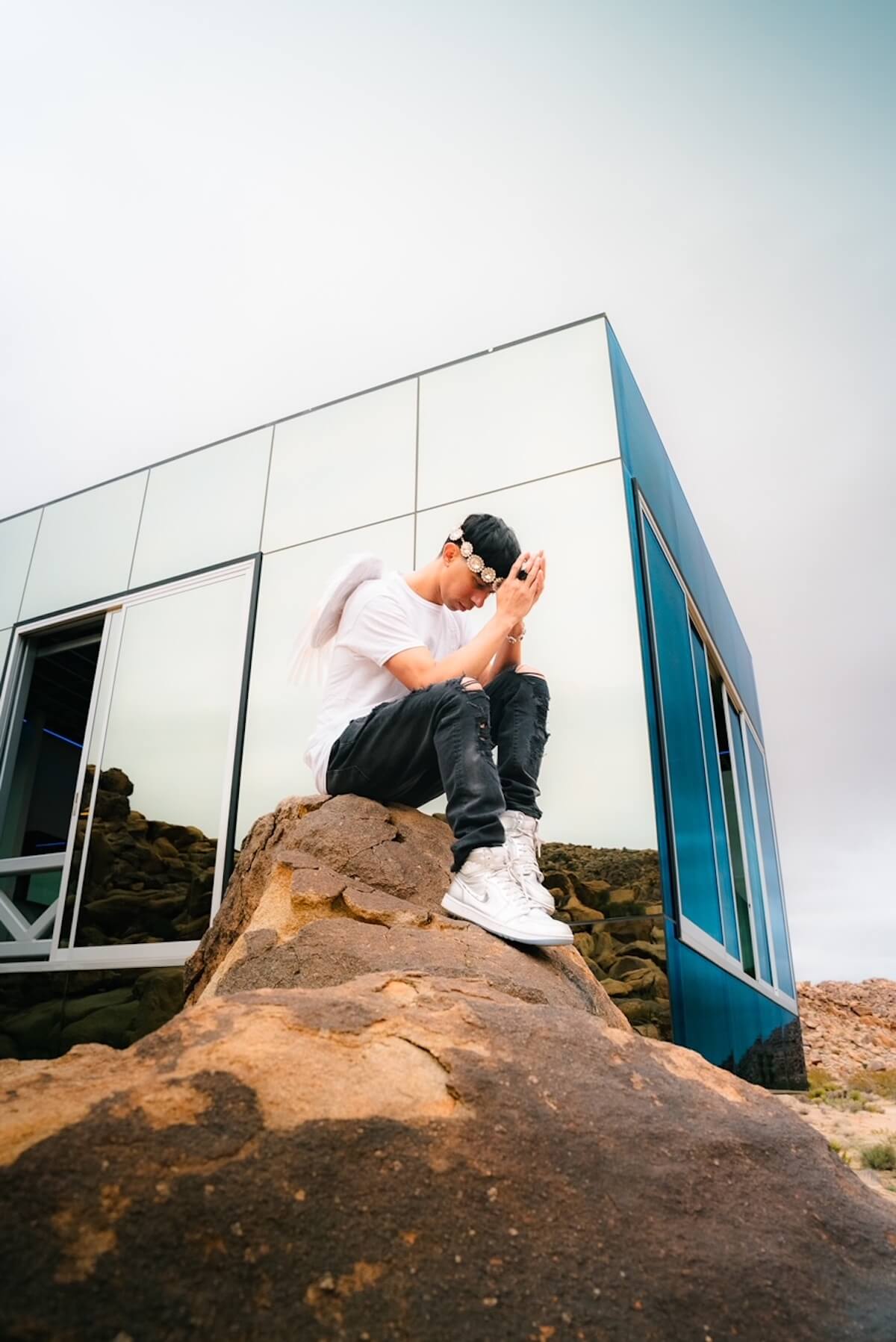 Max Louis in the desert near mirror building