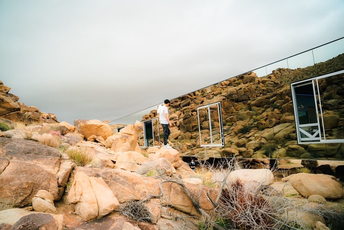 Max Louis in the desert near mirror building