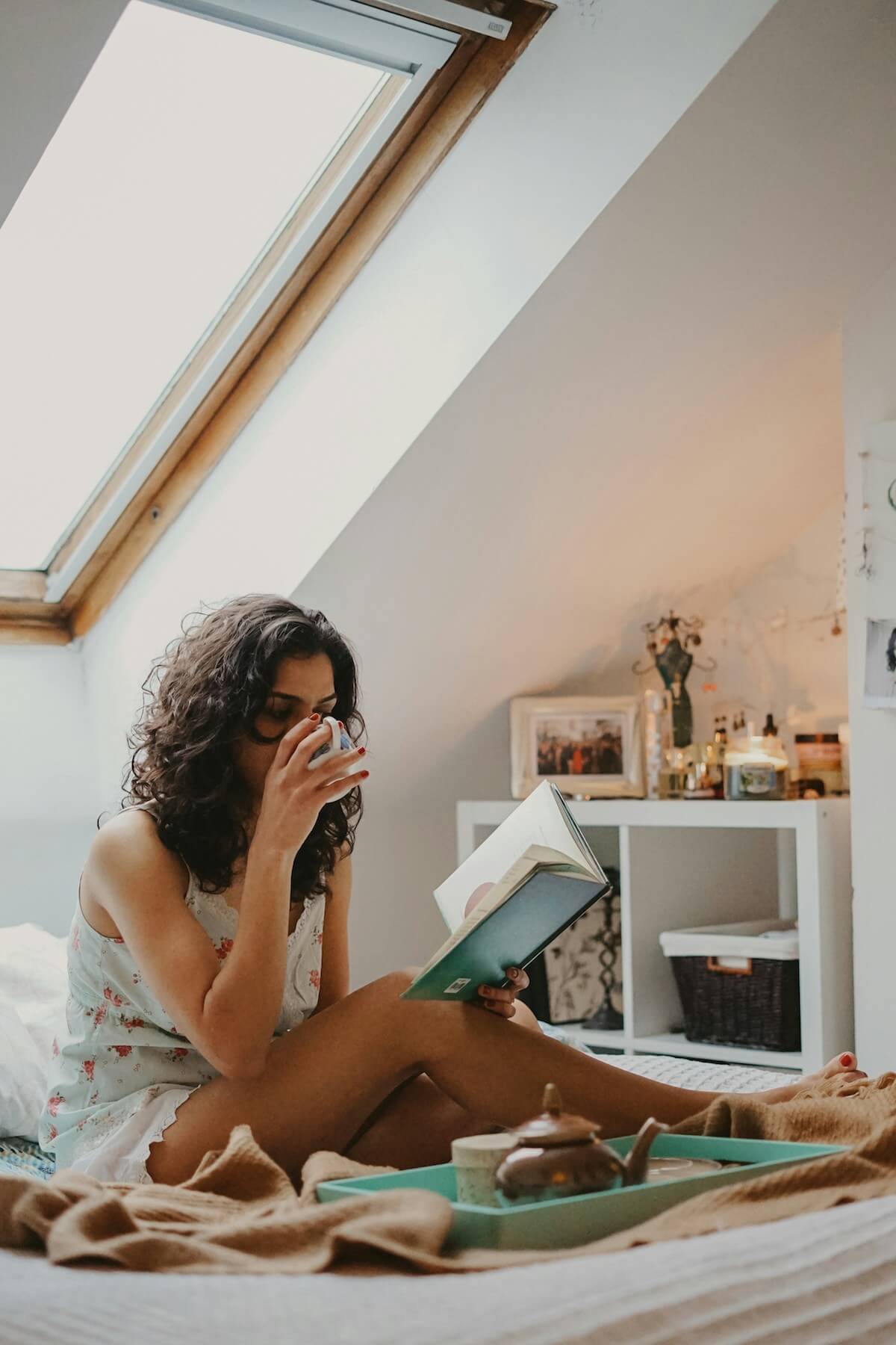 Unsplash: Woman drinking tea and reading quietly by Toa Heftiba