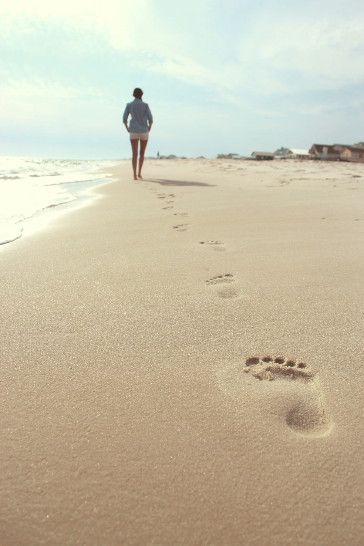 Unsplash: Woman talking in sand on the beach by Zack Minor
