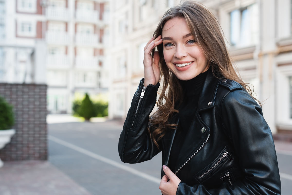 happy woman wearing a leather jacket