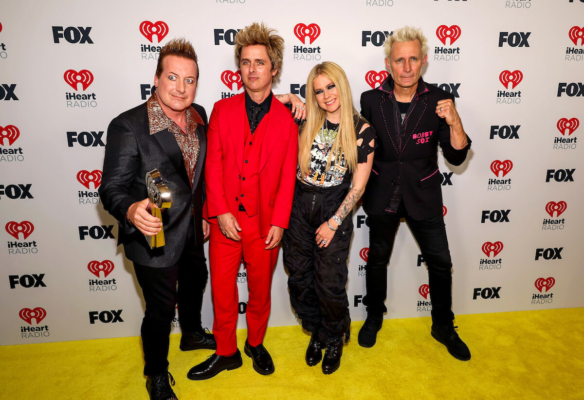 LOS ANGELES, CALIFORNIA - APRIL 01: (FOR EDITORIAL USE ONLY) (L-R) Tré Cool, Billie Joe Armstrong, and Mike Dirnt of Green Day, winners of the Landmark Award, and Avril Lavigne (2nd from R) attend the 2024 iHeartRadio Music Awards at Dolby Theatre in Los Angeles, California on April 01, 2024. Broadcasted live on FOX. (Photo by Jesse Grant/Getty Images for iHeartRadio)
