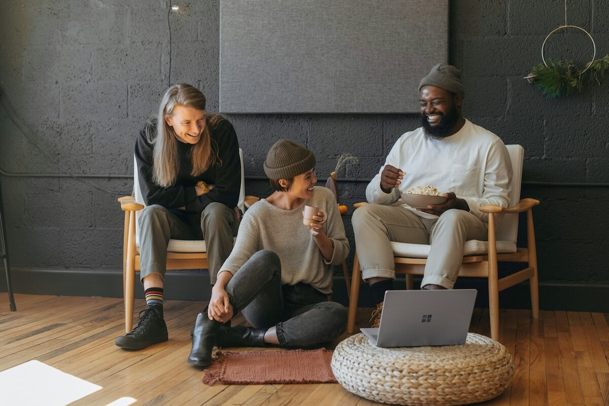 Unsplash: Friends hanging out and laughing looking at Microsoft Surface tablet