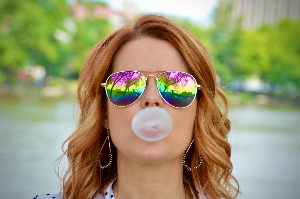 Unsplash: Woman blowing bubble gum wearing sunglasses by Andra C Taylor Jr.
