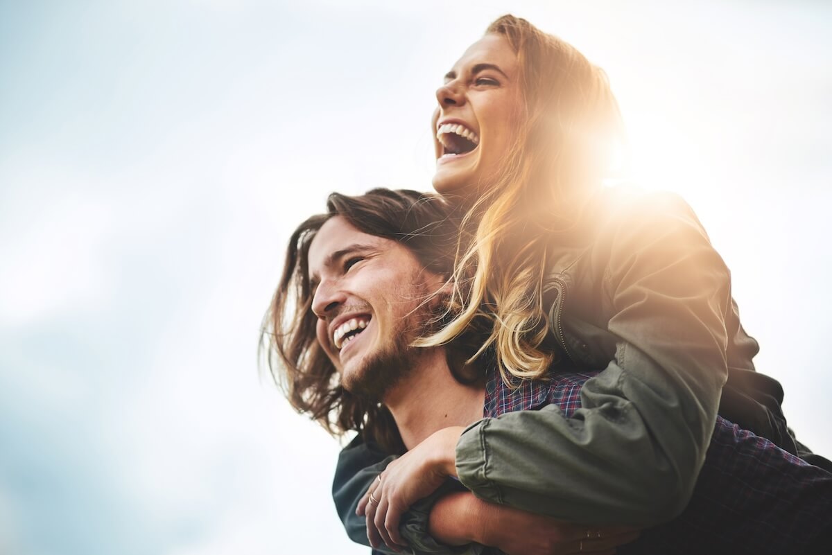 Shutterstock: Live, laugh, love. Shot of a happy young couple having fun outside.