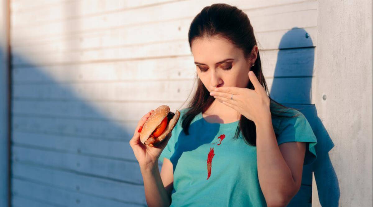 Shutterstock: Woman spills ketchup on shirt