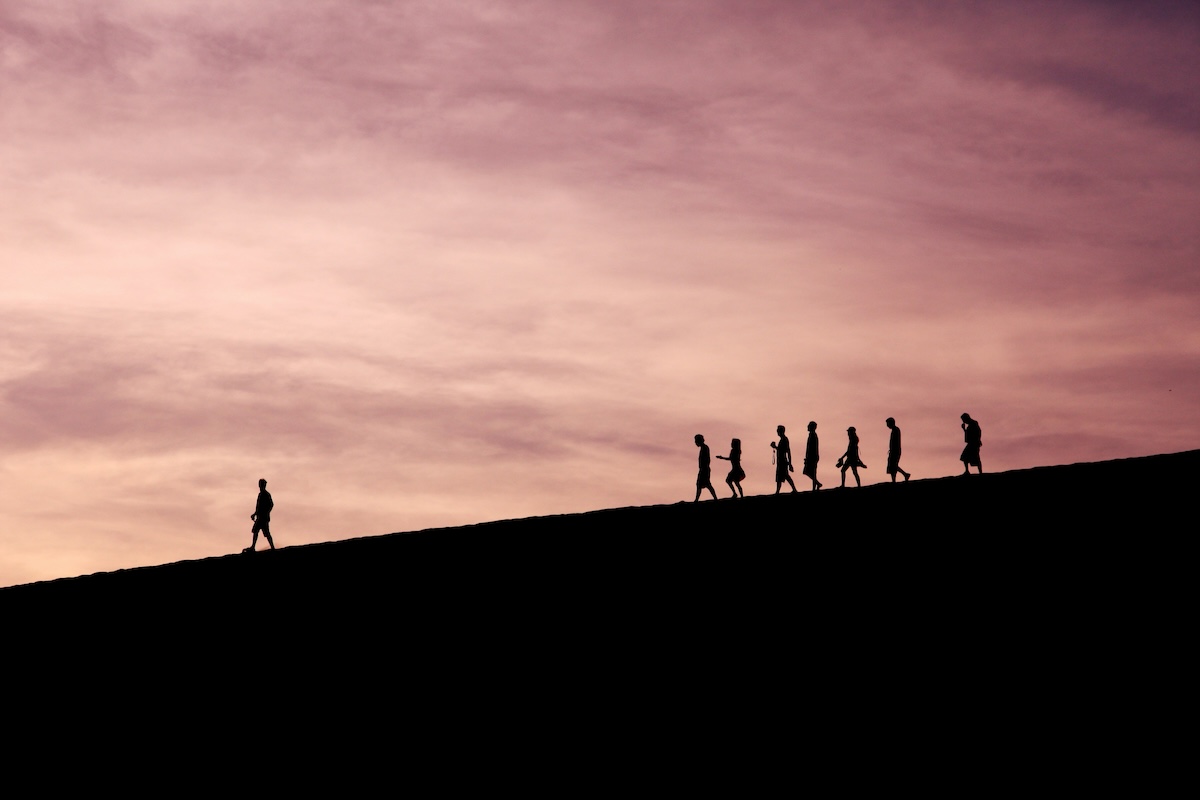 Unsplash: Person leading hike on a hill by Jehyun Sung