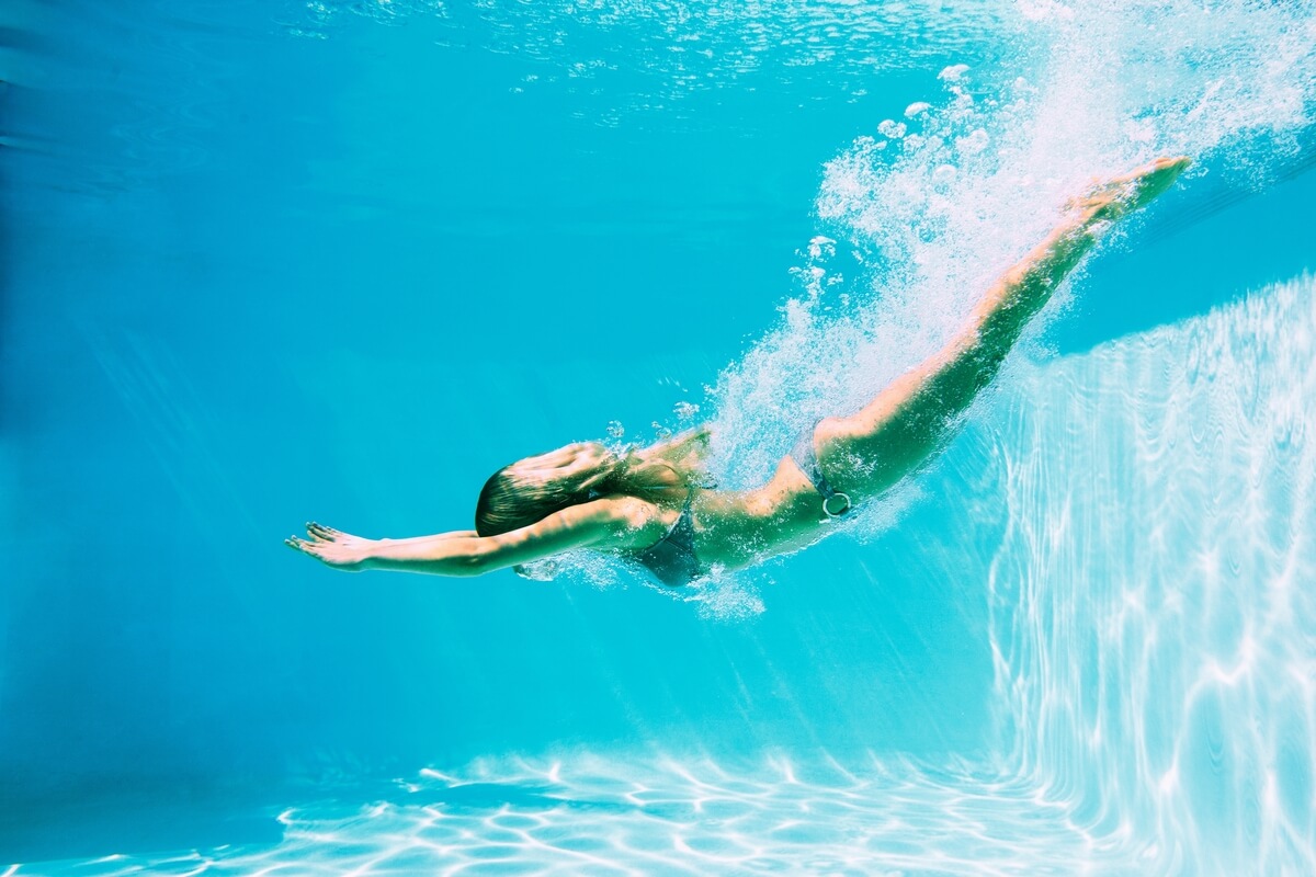 woman diving into pool
