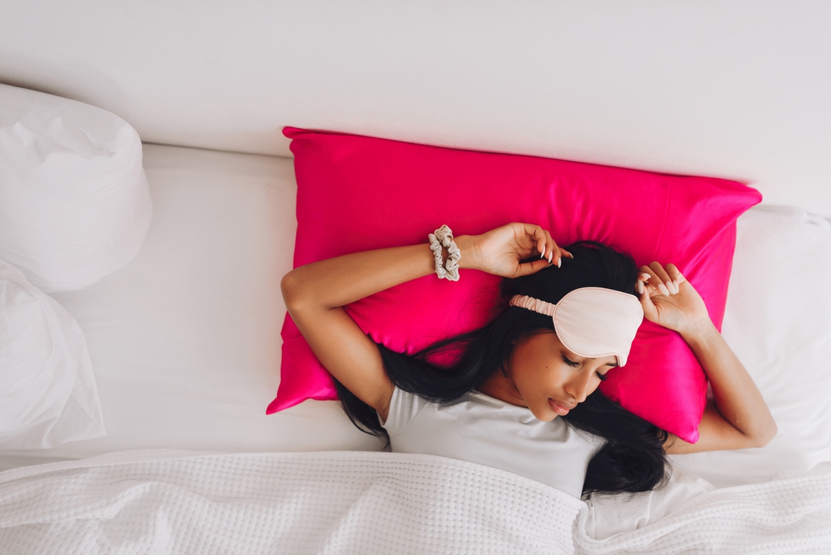 woman laying on a silk pillowcase