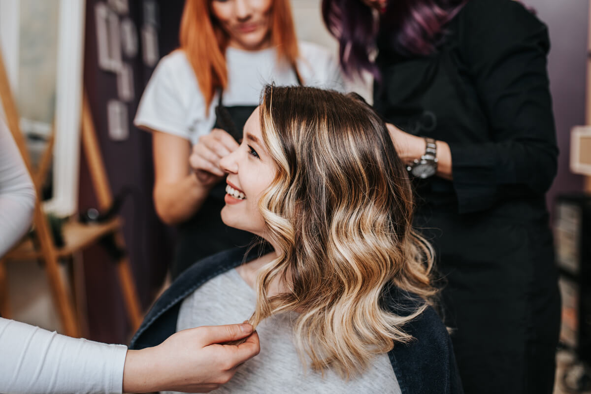 young woman getting hair dyed