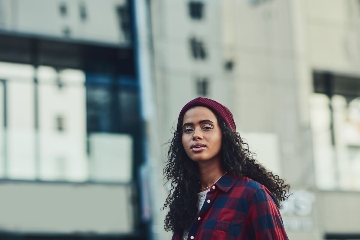 Shutterstock: City, fashion and portrait of woman outdoor as tourist for holiday, travel or vacation abroad. Clothes, outfit and winter with confident model person in urban town for casual style or wardrobe