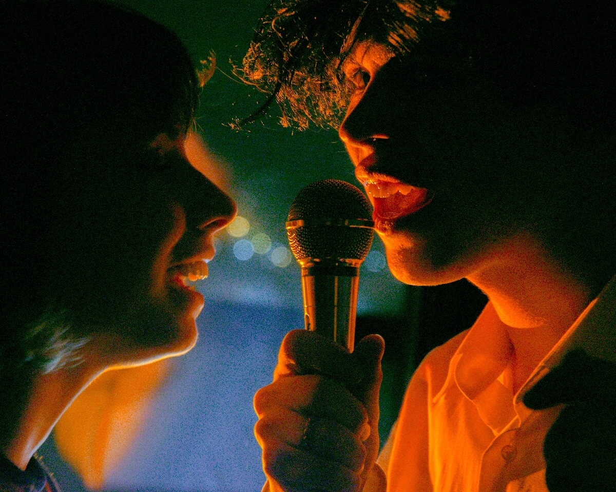 Unsplash: Couple singing karaoke by daniil onischeknko