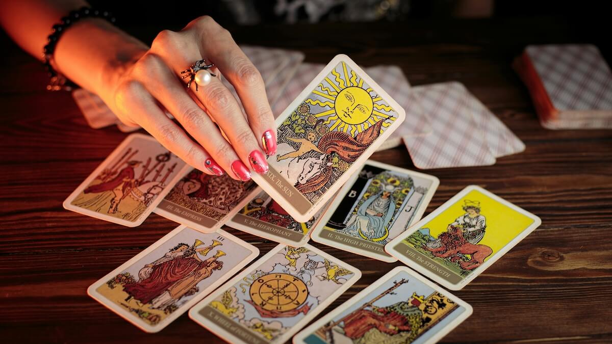 Unsplash: Woman pulling tarot card by Petr Sidorov