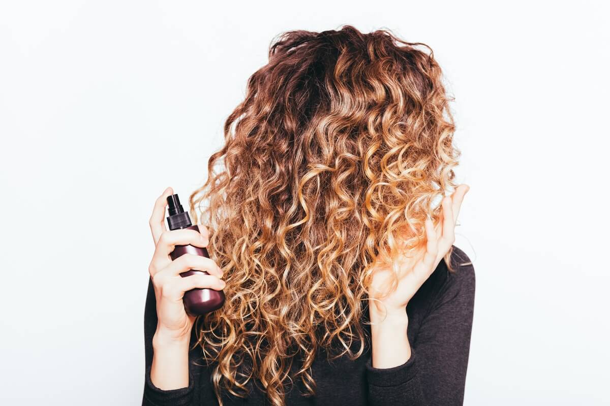 woman adding curl products