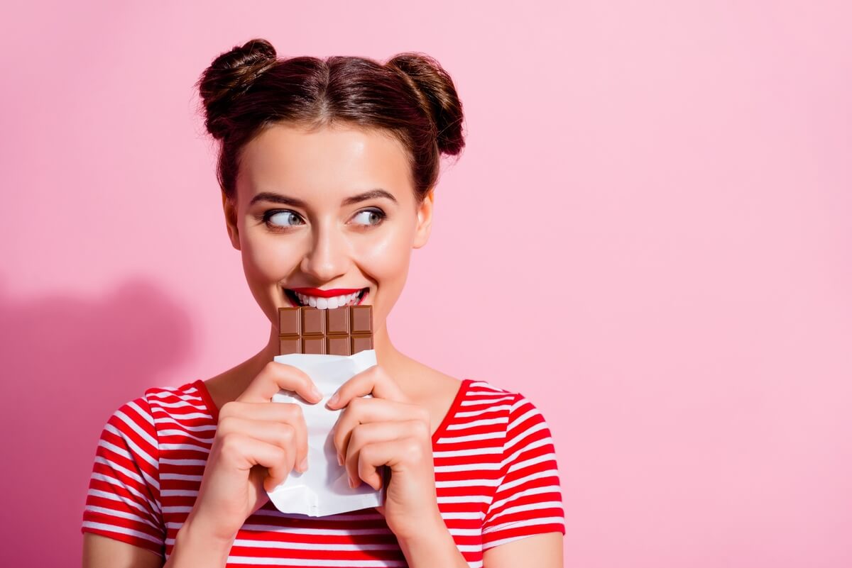 woman eating chocolate bar