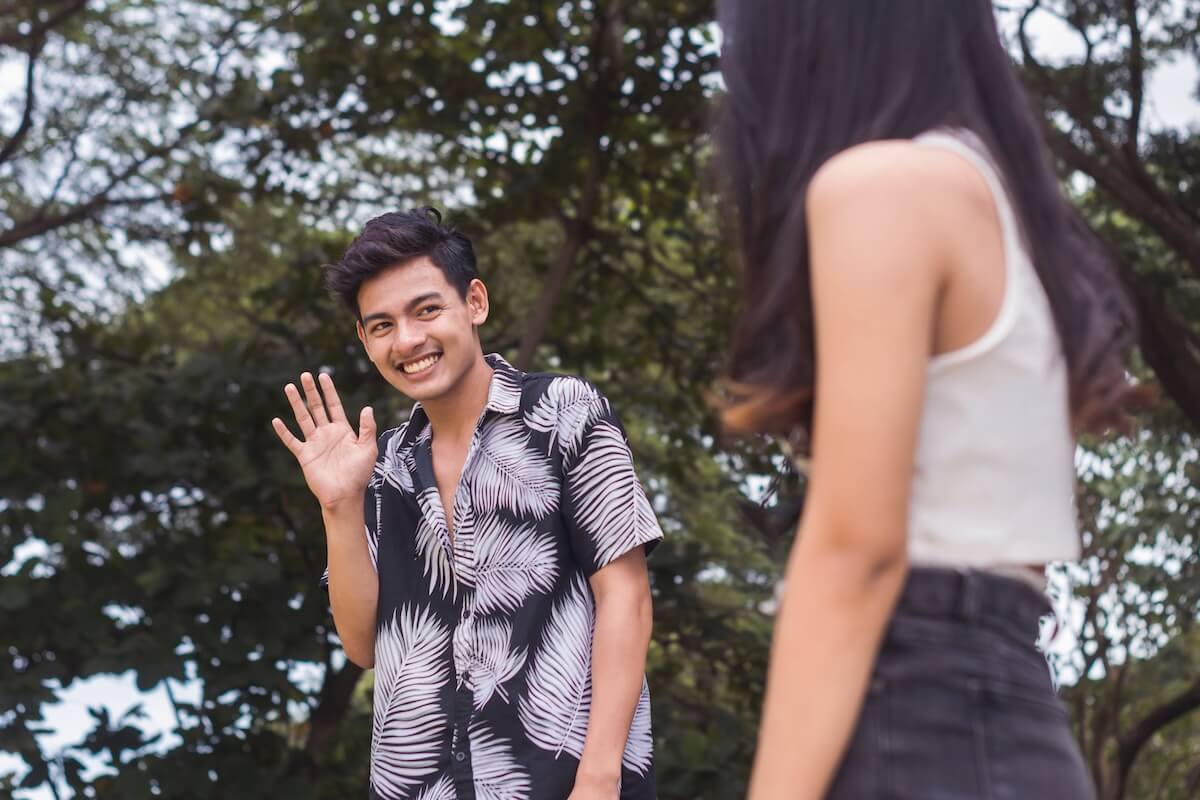 Shutterstock: A young awkward man saying hi to his crush. Attracted to a woman outside the park. Being shy about his personality and looks.