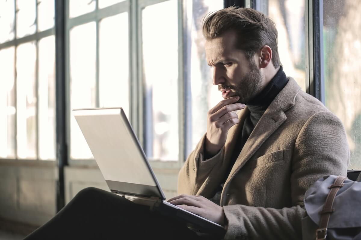 Shutterstock: Unsplash bearded man thinking before replying to computer message by Bruce Mars
