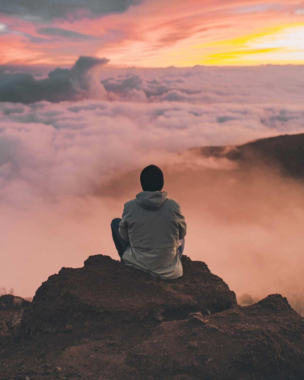 Unsplash: Figure thinking looking out over clouds by Ian Stauffer