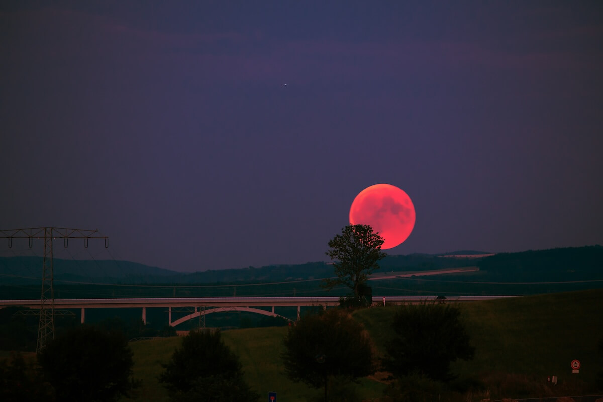 Unsplash: Full blood moon over bridge by Robert Wiedemann