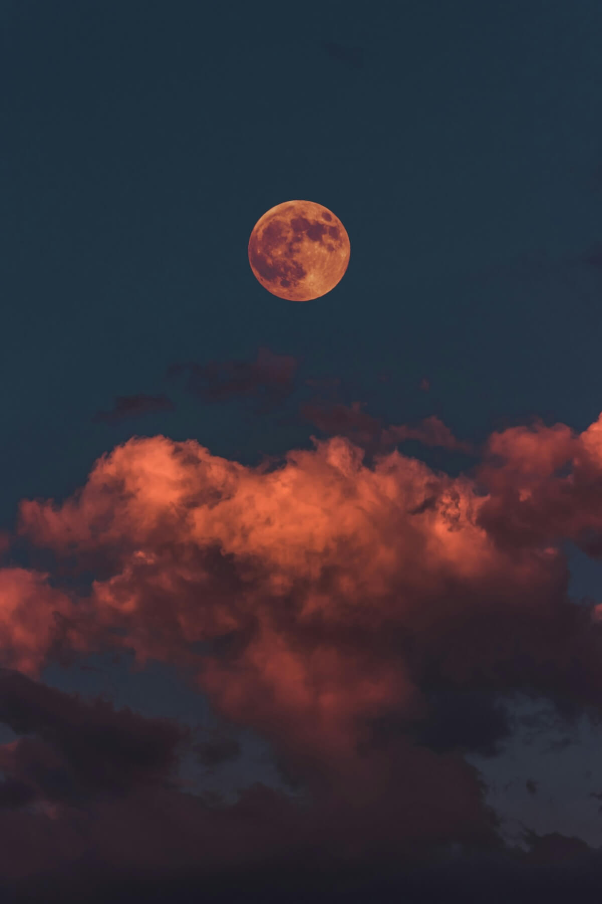 Unsplash: Light blood moon over colorful clouds by Altinay Dinc