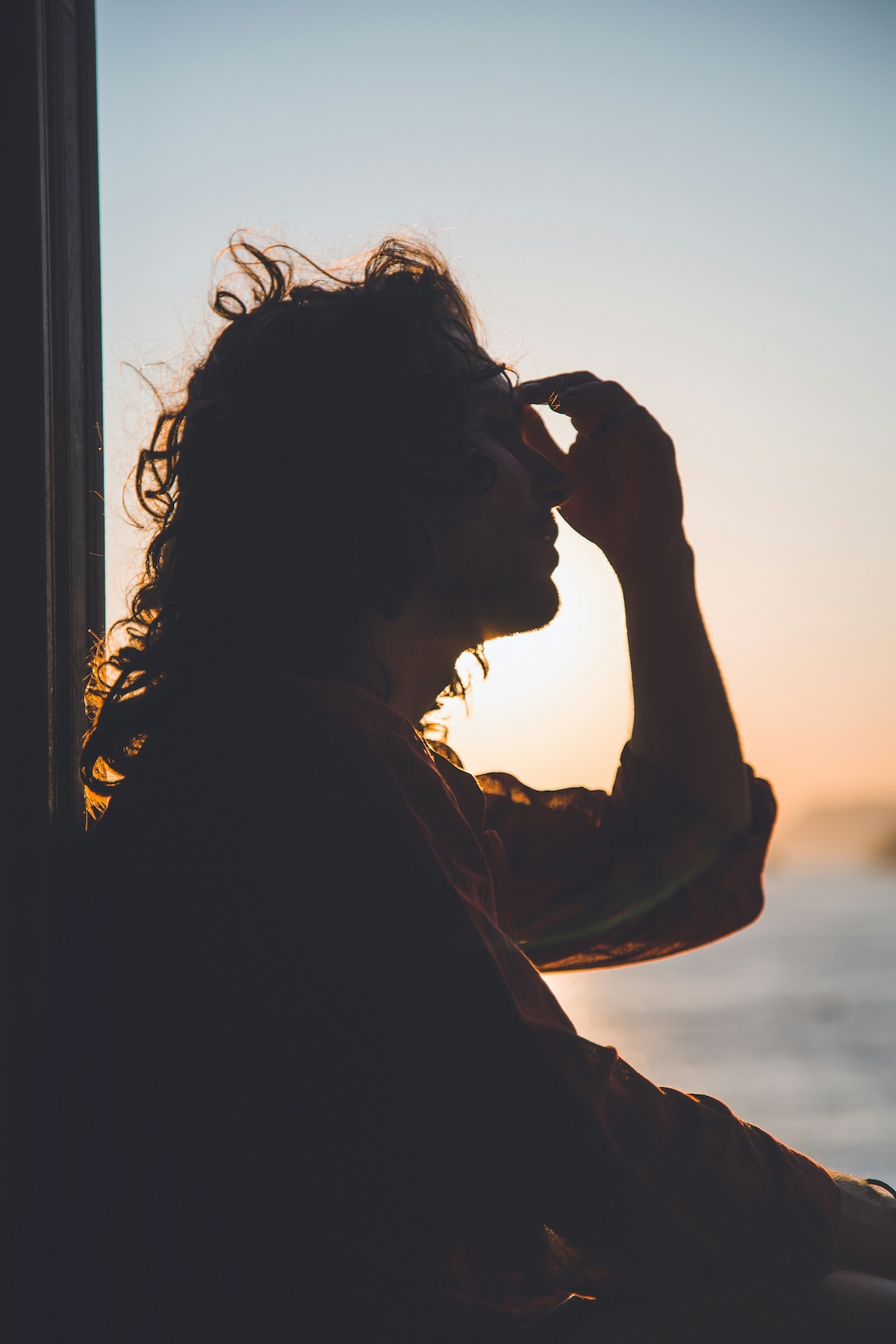 Unsplash: person with headache against sunset by Matteo Vistocco