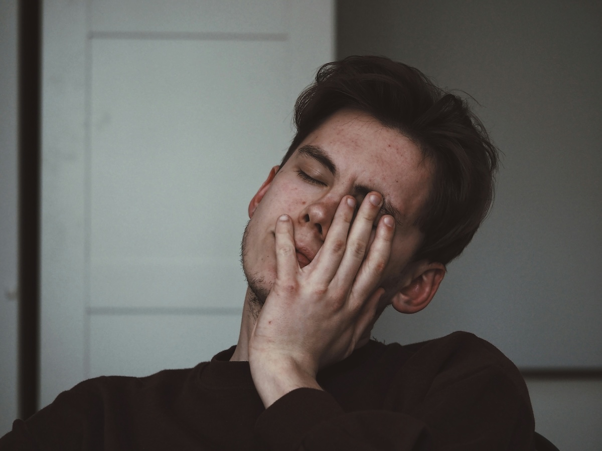 Unsplash: tired man with headache by Adrian swancar