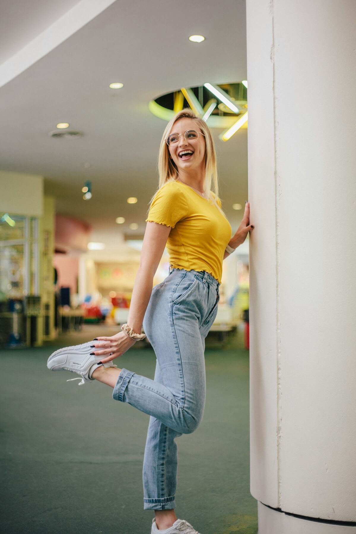 Unsplash: Woman wearing mom jeans at mall by Ryan Jacobson