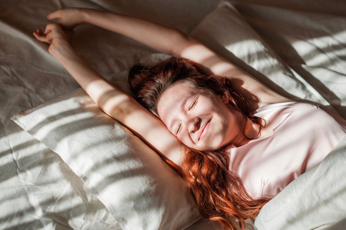 woman smiling in bed
