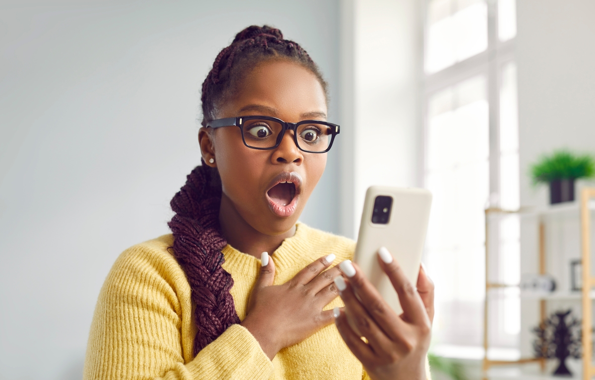 shocked woman looking at phone