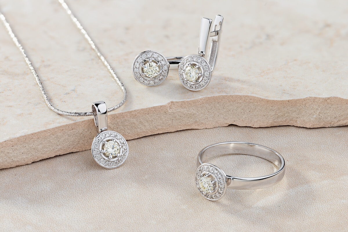 Shutterstock: Elegant jewelry set of white gold ring, necklace and earrings with diamonds. Silver jewellery set with gemstones. Product still life concept