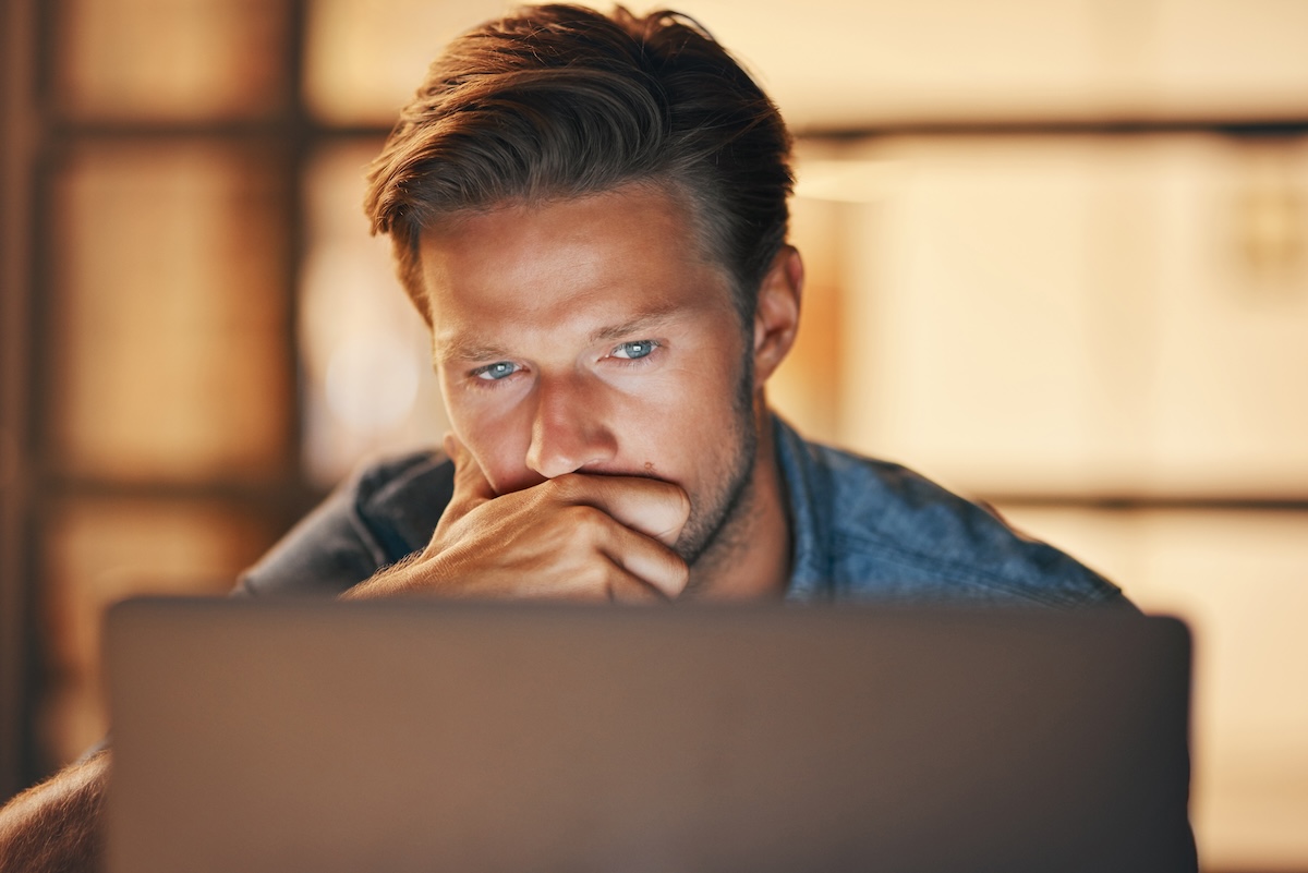 Shutterstock: Pulling an all-nighter to complete a project. a handsome young man looking thoughtful while working late in his office.