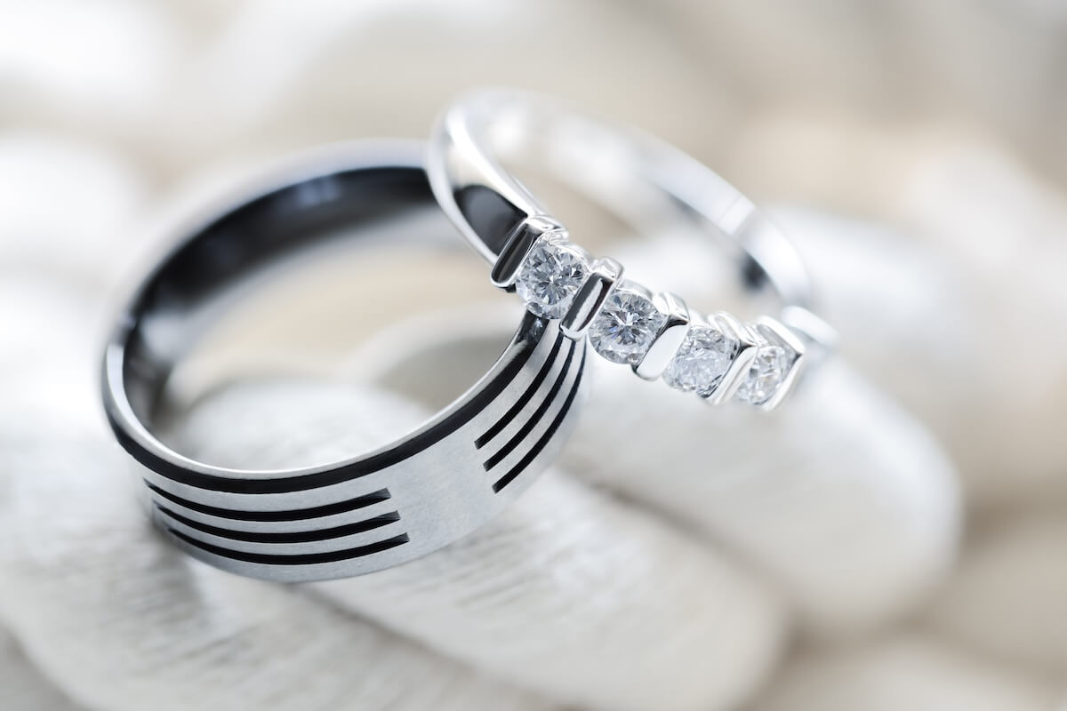 Shutterstock: Two platinum diamond wedding rings on white rope background