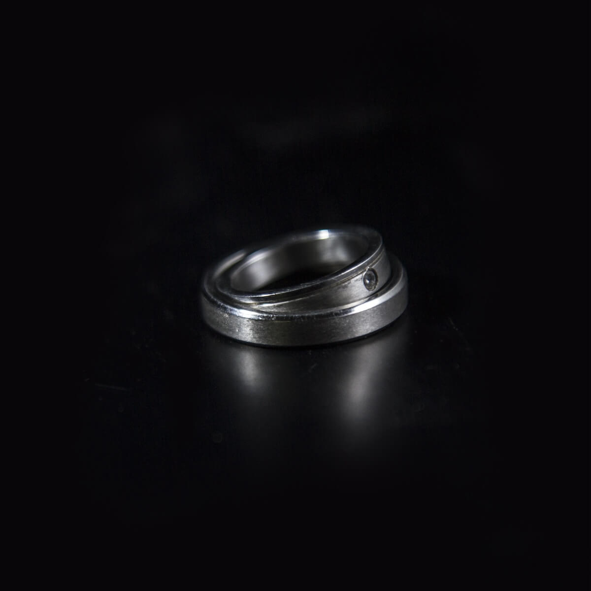 Shutterstock: titanium wedding rings on black background