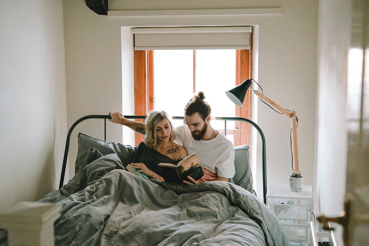 Unsplash: Couple reading routine in bed by Toa Heftiba