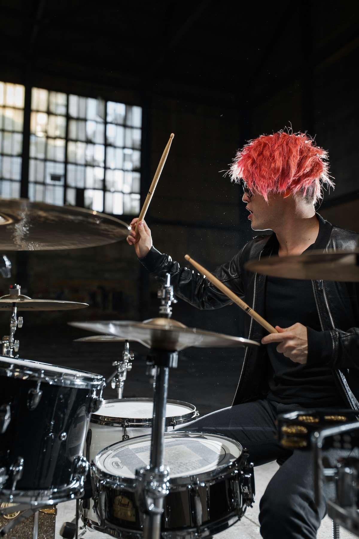 Unsplash: Drummer with pink hair sitting at drums by Valery Sysoev