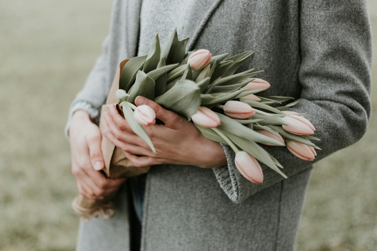 Unsplash: Hands holding pink tulip bouquet by Priscilla du preez