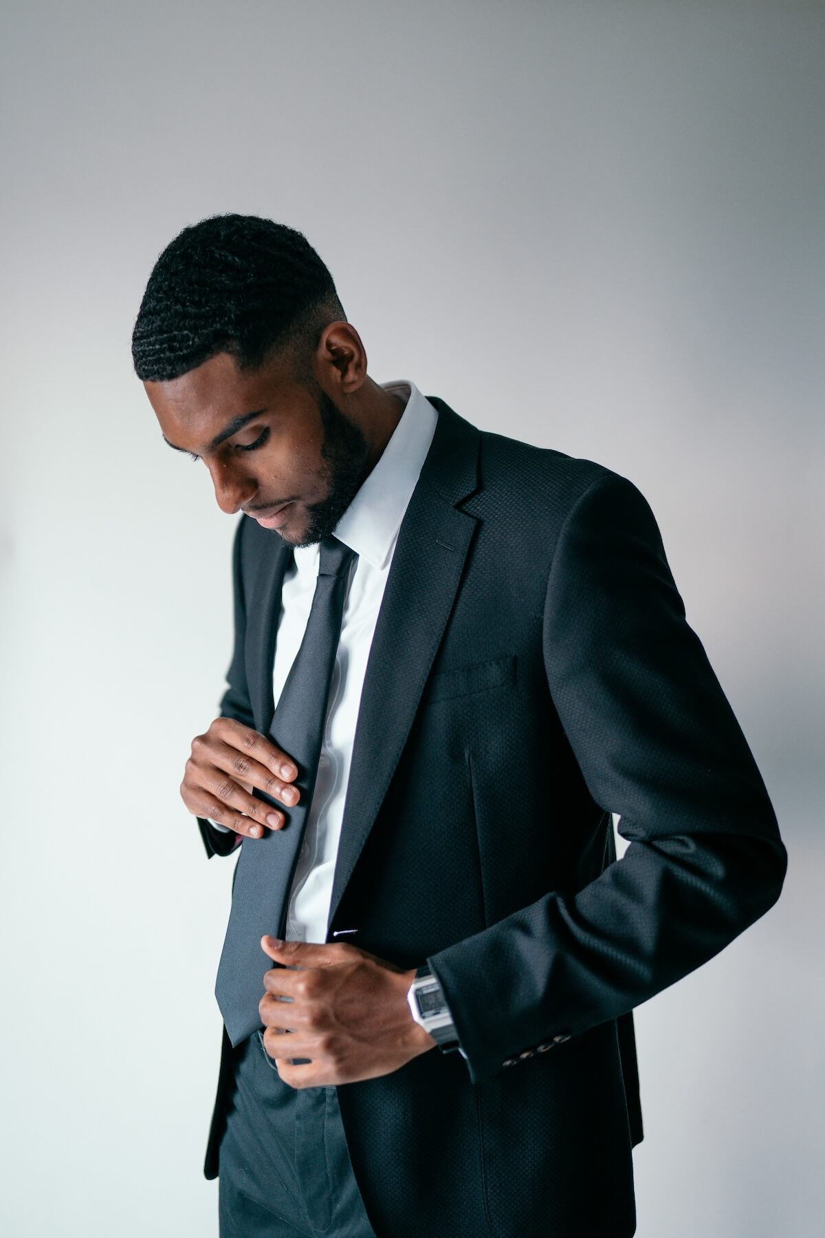Unsplash: Man in black suit and tie by Brock Wegner