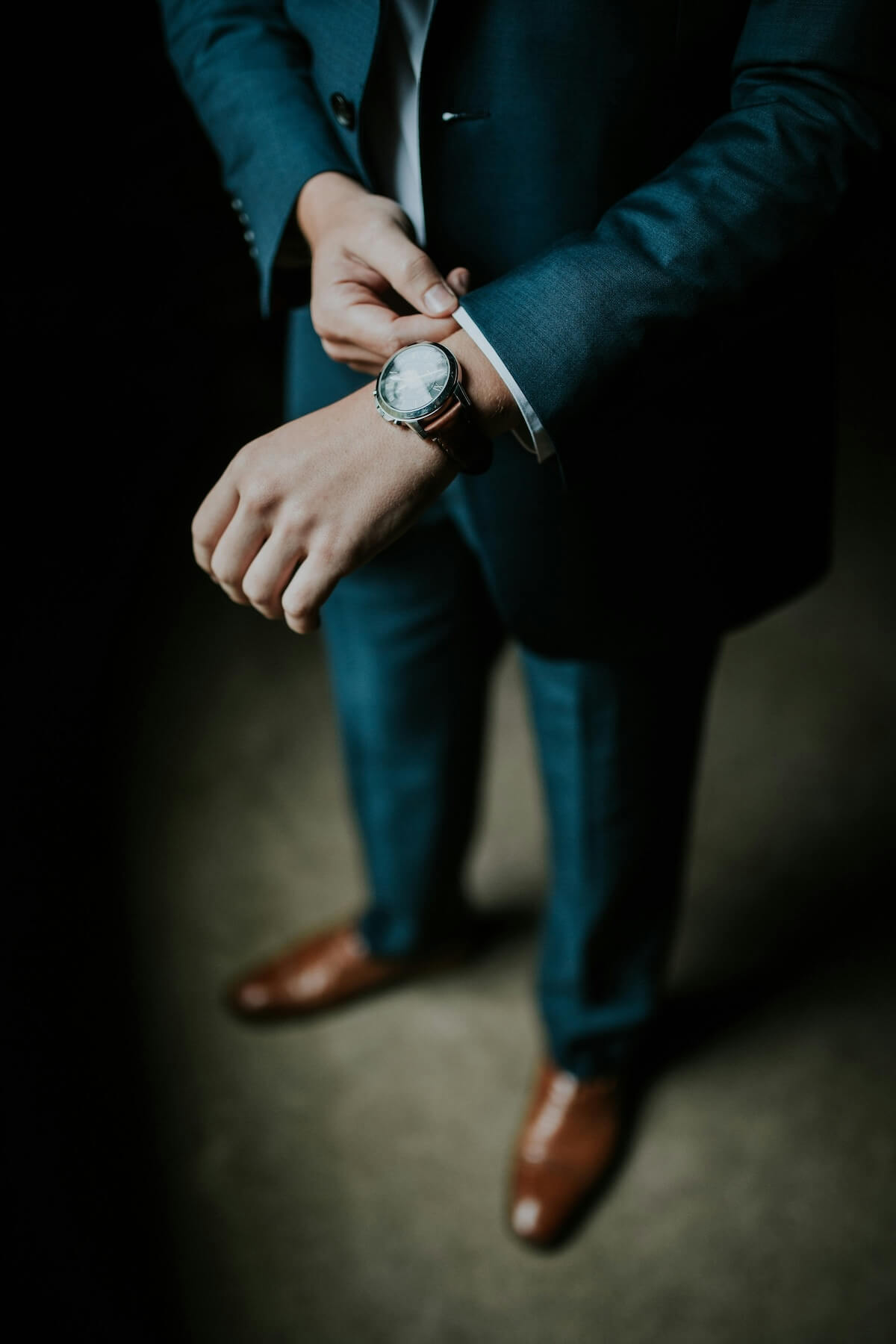Unsplash: Man in blue suit with watch be Jeremy Beadle