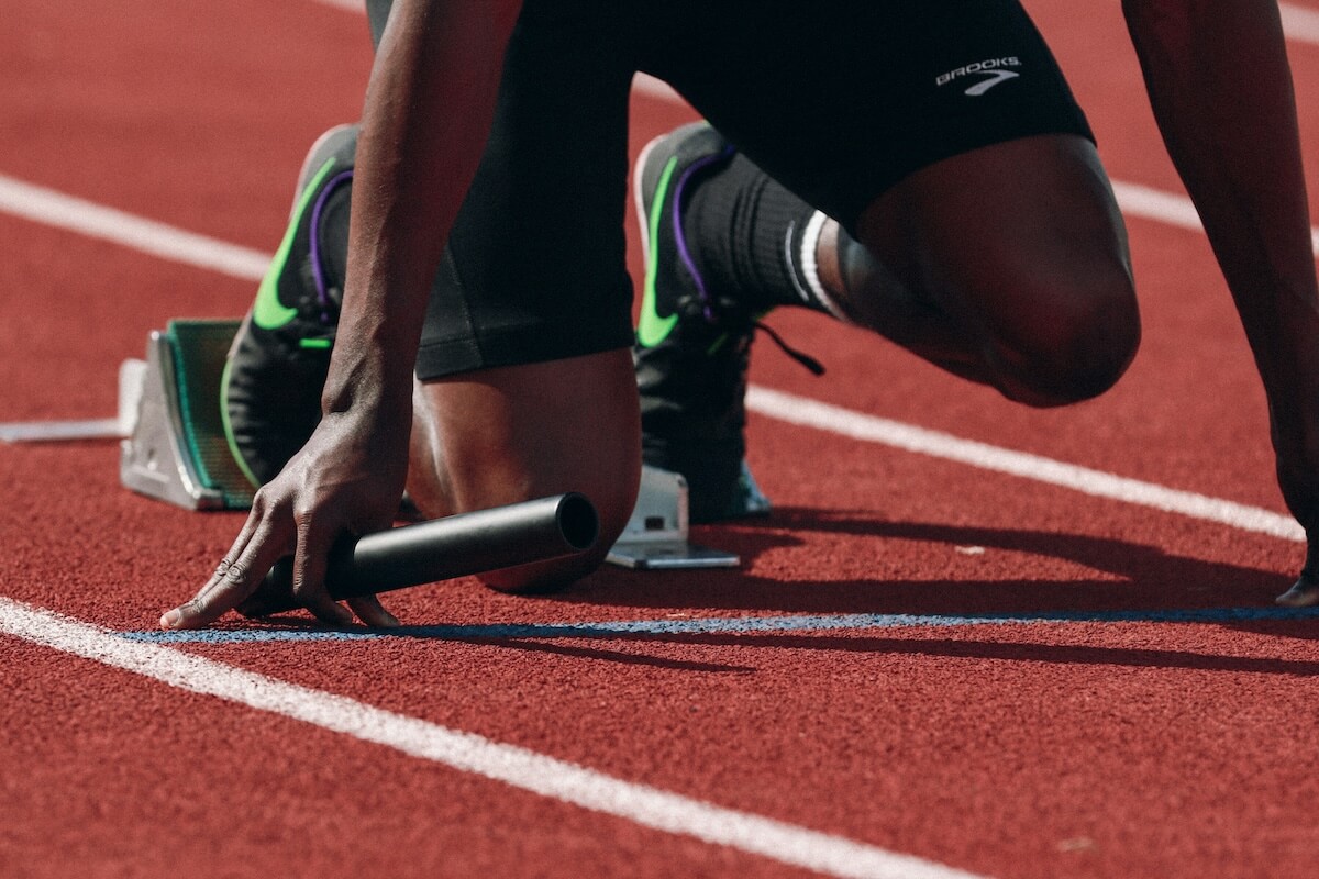 Unsplash: person setting up for track and field by braden collum