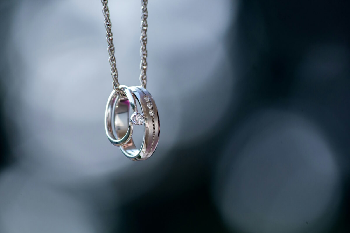 Unsplash: Silver wedding rings on necklace by Atul vinayak