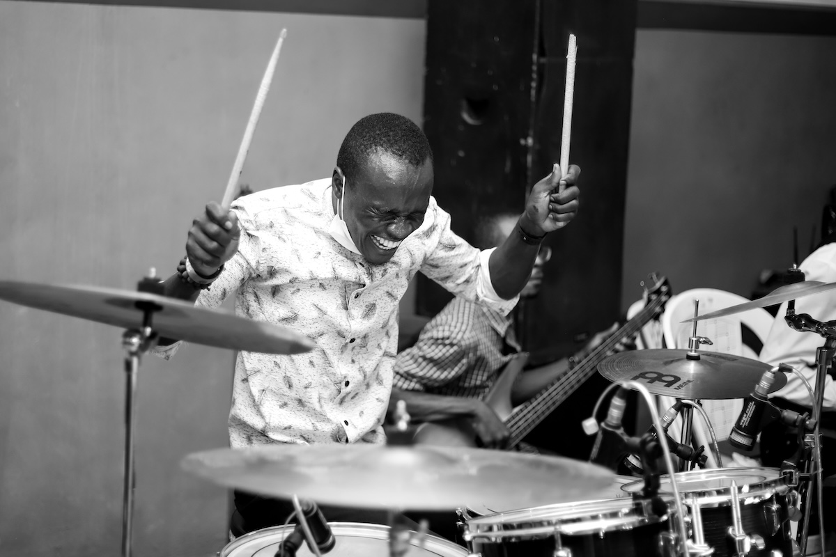 Unsplash: Smiling drummer in black and white by Adeyemi Emmanuel Abebayo